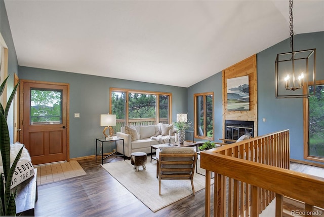 31150 Manitoba Dr, Evergreen, CO 80439 - living room with vaulted ceiling, wood finished floors, a large fireplace, and a chandelier