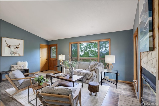 31150 Manitoba Dr, Evergreen, CO 80439 - living area with lofted ceiling, wood finished floors, and a glass covered fireplace