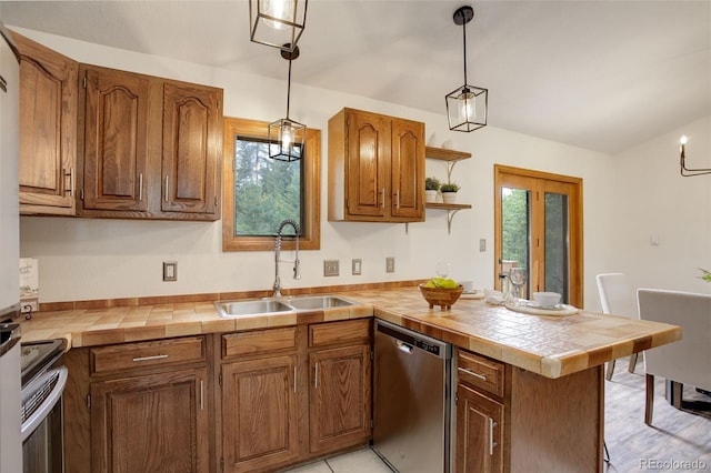 31150 Manitoba Dr, Evergreen, CO 80439 - kitchen featuring appliances with stainless steel finishes, a peninsula, healthy amount of natural light, and decorative light fixtures