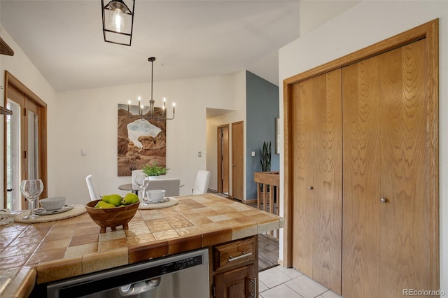 31150 Manitoba Dr, Evergreen, CO 80439 - kitchen featuring dishwasher, a chandelier, lofted ceiling, tile countertops, and light tile patterned flooring
