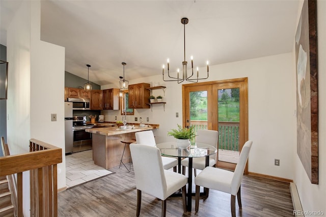 31150 Manitoba Dr, Evergreen, CO 80439 - dining area with a baseboard heating unit, lofted ceiling, light wood-type flooring, and a chandelier