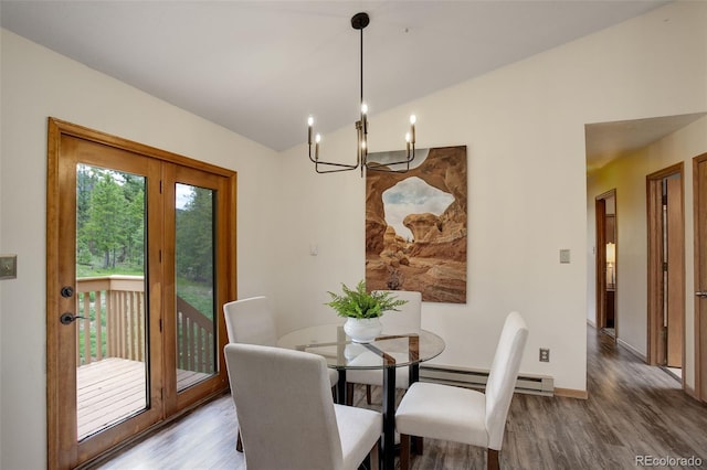 31150 Manitoba Dr, Evergreen, CO 80439 - dining room featuring wood finished floors, a baseboard heating unit, a chandelier, and lofted ceiling