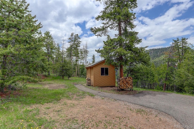 31150 Manitoba Dr, Evergreen, CO 80439 - view of yard with an outdoor structure and a wooded view