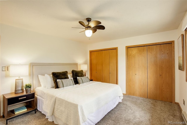 31150 Manitoba Dr, Evergreen, CO 80439 - bedroom with carpet floors, multiple closets, a baseboard heating unit, and ceiling fan