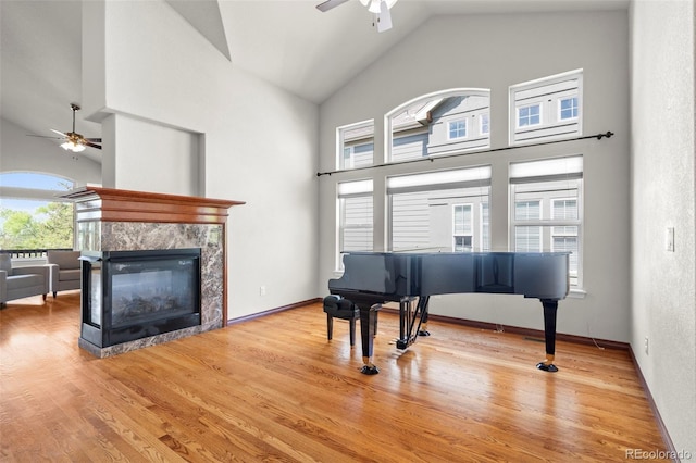 1513 Cannon Mountain Dr, Longmont, CO 80503 - sitting room with ceiling fan, a fireplace, high vaulted ceiling, and wood finished floors
