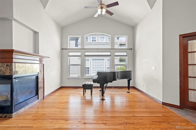 1513 Cannon Mountain Dr, Longmont, CO 80503 - living area with a ceiling fan, light wood finished floors, a tiled fireplace, and high vaulted ceiling
