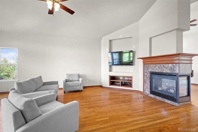 1513 Cannon Mountain Dr, Longmont, CO 80503 - living area featuring ceiling fan, a fireplace, wood finished floors, and high vaulted ceiling