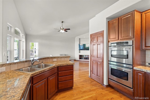1513 Cannon Mountain Dr, Longmont, CO 80503 - kitchen with a sink, stainless steel appliances, light wood-type flooring, ceiling fan, and open floor plan