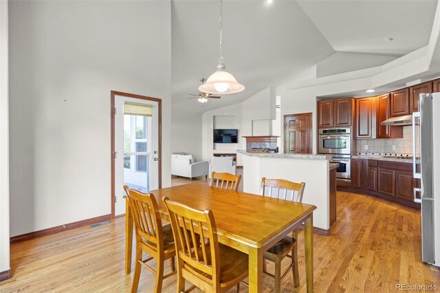 1513 Cannon Mountain Dr, Longmont, CO 80503 - dining area featuring vaulted ceiling, ceiling fan, light wood-style flooring, and baseboards