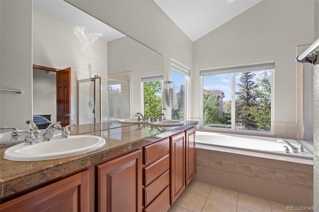1513 Cannon Mountain Dr, Longmont, CO 80503 - bathroom featuring a shower stall, tile patterned flooring, a bath, lofted ceiling, and double vanity