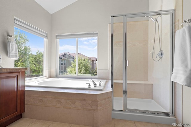 1513 Cannon Mountain Dr, Longmont, CO 80503 - full bath featuring tile patterned flooring, a shower stall, a bath, vaulted ceiling, and vanity