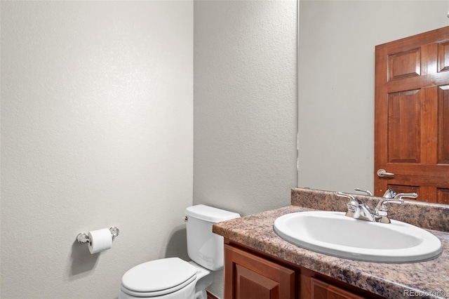 1513 Cannon Mountain Dr, Longmont, CO 80503 - bathroom featuring a textured wall, toilet, and vanity