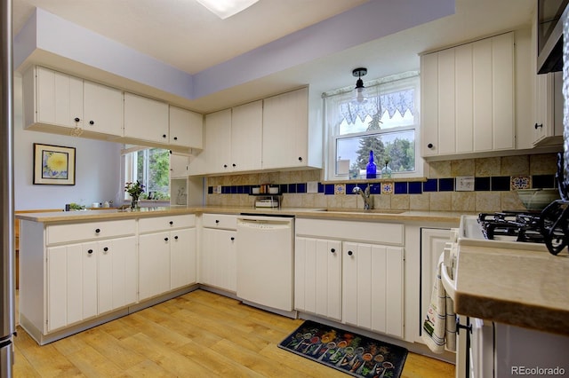 10373 W 75th Ave, Arvada, CO 80005 - kitchen with white appliances, light countertops, light wood-type flooring, decorative backsplash, and white cabinetry