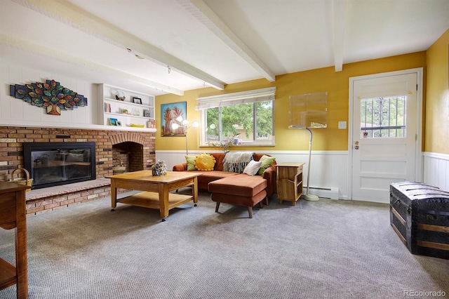 10373 W 75th Ave, Arvada, CO 80005 - living room with a baseboard radiator, a wainscoted wall, carpet flooring, a brick fireplace, and beam ceiling