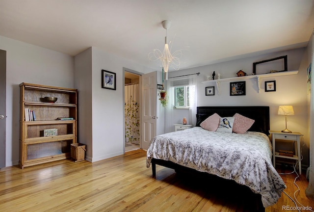 10373 W 75th Ave, Arvada, CO 80005 - bedroom with a chandelier and wood finished floors
