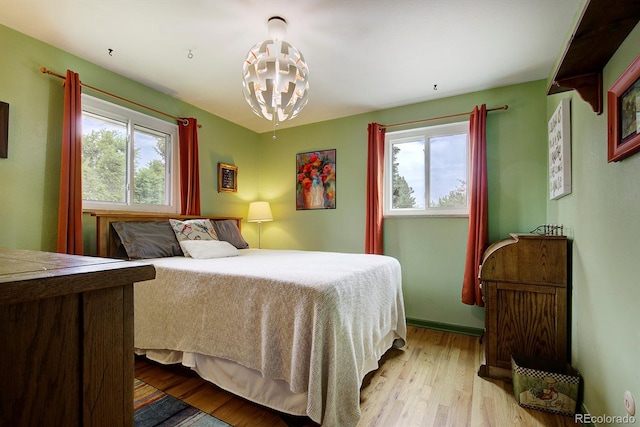 10373 W 75th Ave, Arvada, CO 80005 - bedroom featuring multiple windows and light wood-type flooring