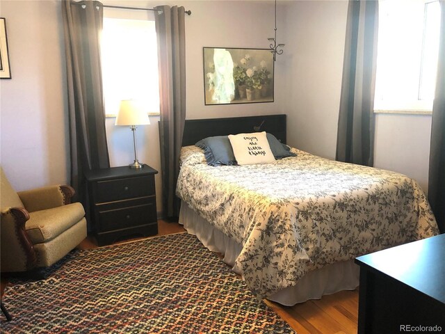 10373 W 75th Ave, Arvada, CO 80005 - bedroom featuring multiple windows and wood finished floors