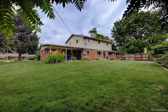 10373 W 75th Ave, Arvada, CO 80005 - rear view of house with brick siding, a chimney, and a sunroom