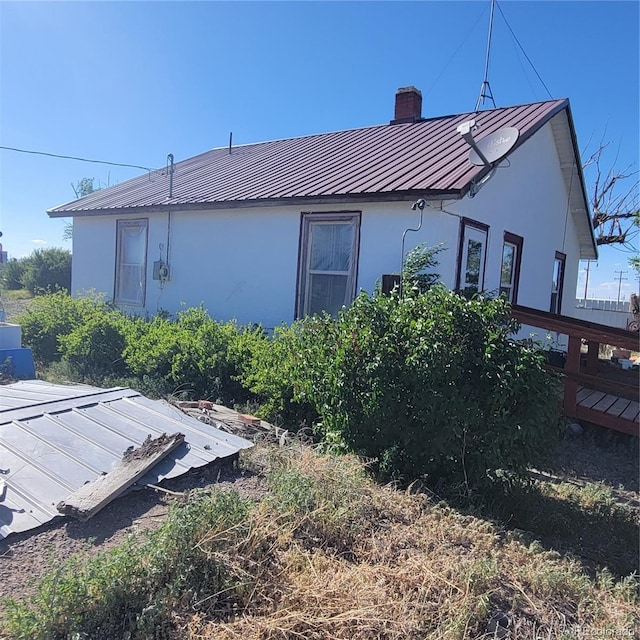 view of property exterior with a deck