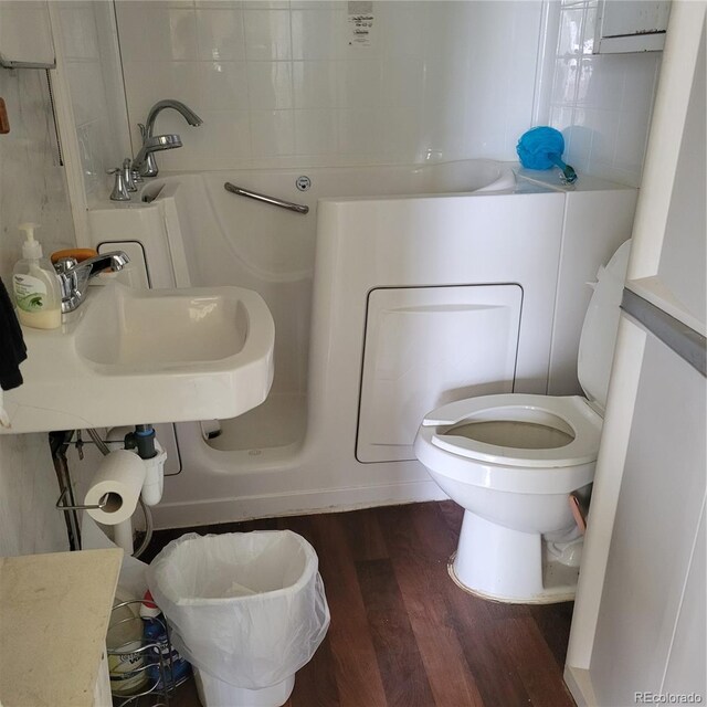 bathroom featuring sink, toilet, and wood-type flooring