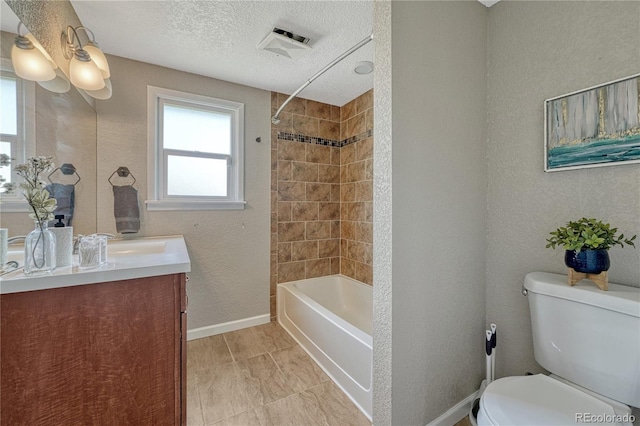 bathroom featuring toilet, vanity, baseboards, bathtub / shower combination, and a textured ceiling