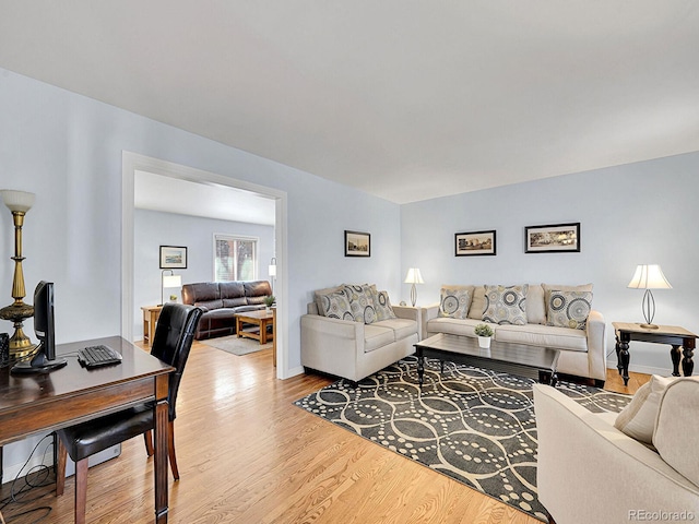 living area featuring baseboards and wood finished floors