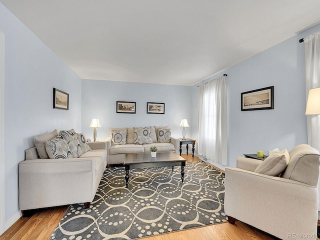 living area featuring baseboards and wood finished floors