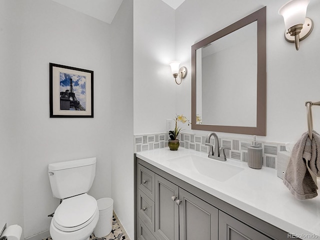 bathroom featuring toilet, tasteful backsplash, baseboard heating, and vanity