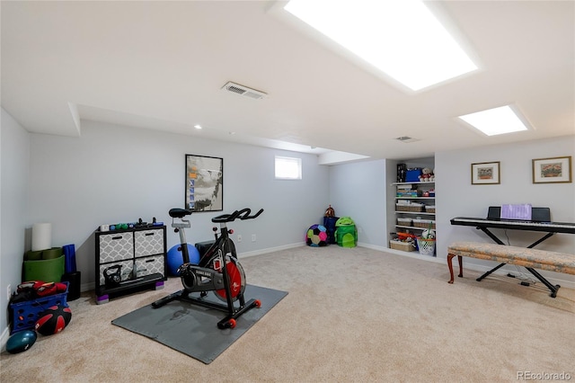 exercise area featuring carpet flooring, visible vents, and baseboards