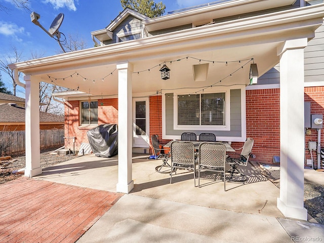 view of patio with fence and outdoor dining area