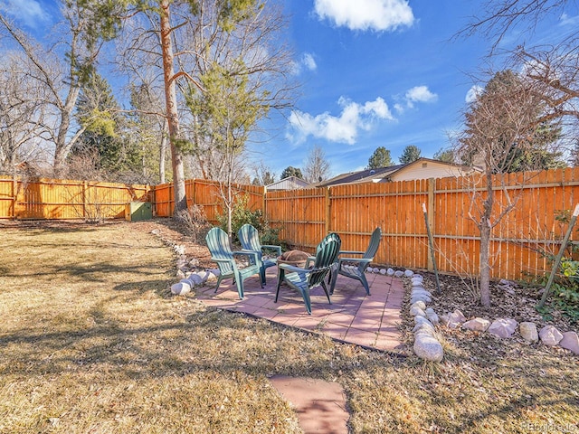 view of yard with an outdoor fire pit, a patio area, and a fenced backyard