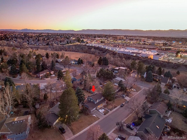 aerial view at dusk featuring a mountain view