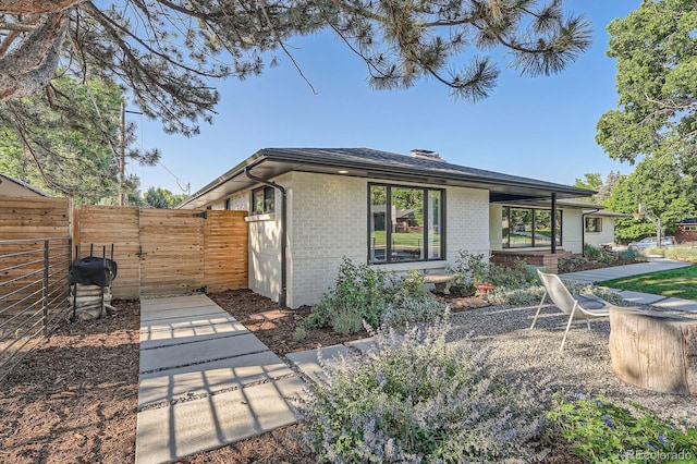 3695 E Dartmouth Ave, Denver, CO 80210 - view of side of home with brick siding and a shingled roof
