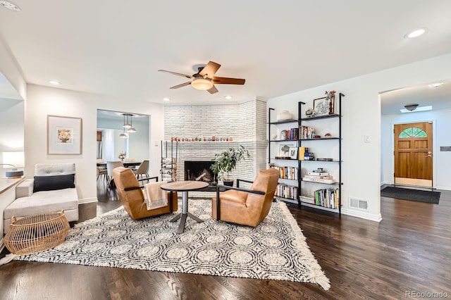 3695 E Dartmouth Ave, Denver, CO 80210 - living area featuring wood finished floors, a brick fireplace, a ceiling fan, and recessed lighting