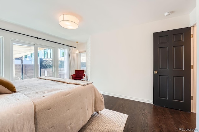 3695 E Dartmouth Ave, Denver, CO 80210 - bedroom with dark wood-type flooring and baseboards