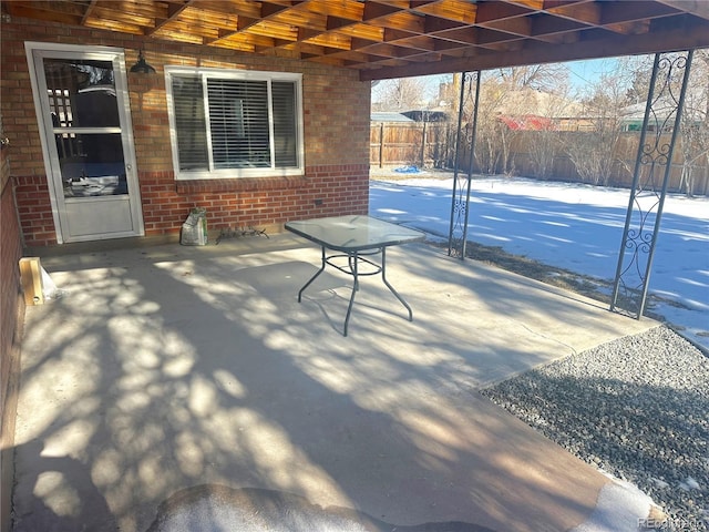 snow covered patio featuring a pergola