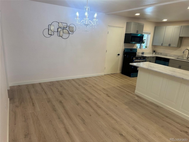 kitchen featuring gray cabinets, dishwasher, sink, electric range, and light hardwood / wood-style flooring