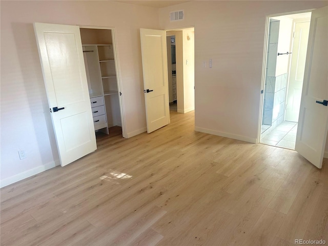 unfurnished bedroom featuring light hardwood / wood-style flooring and a closet