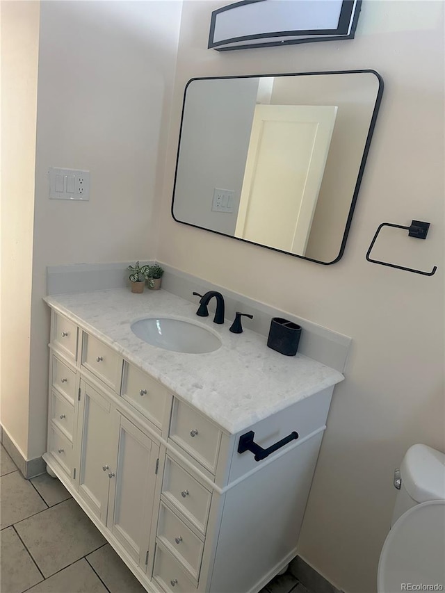 bathroom with vanity, toilet, and tile patterned flooring