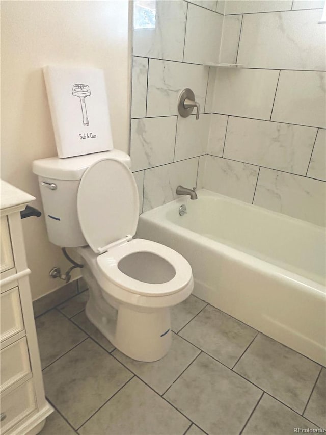 full bathroom featuring vanity, tiled shower / bath combo, tile patterned floors, and toilet