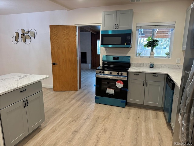 kitchen with light stone counters, light hardwood / wood-style flooring, dishwasher, gray cabinets, and electric stove