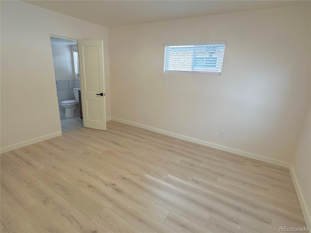 spare room with light hardwood / wood-style floors