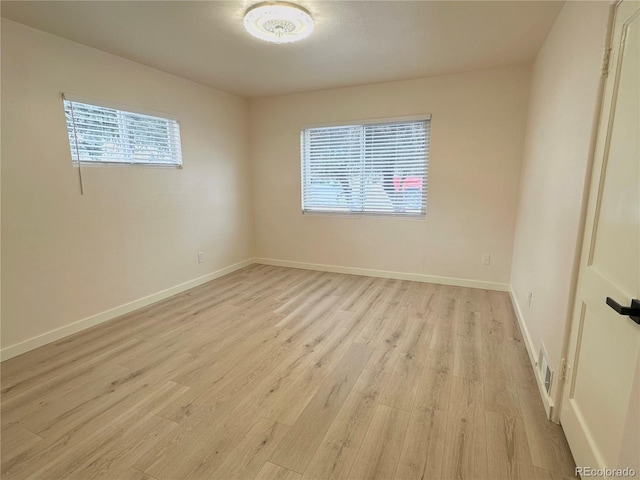 unfurnished room with light hardwood / wood-style flooring