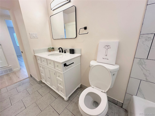 bathroom featuring vanity and toilet