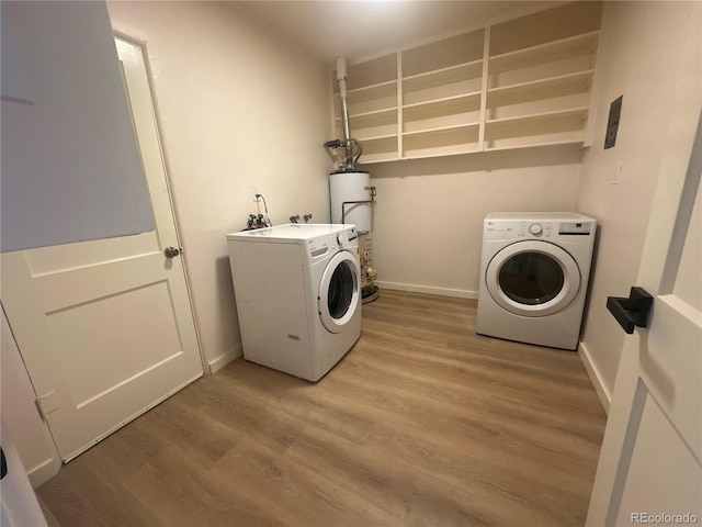 laundry area with hardwood / wood-style flooring, water heater, and washer and dryer