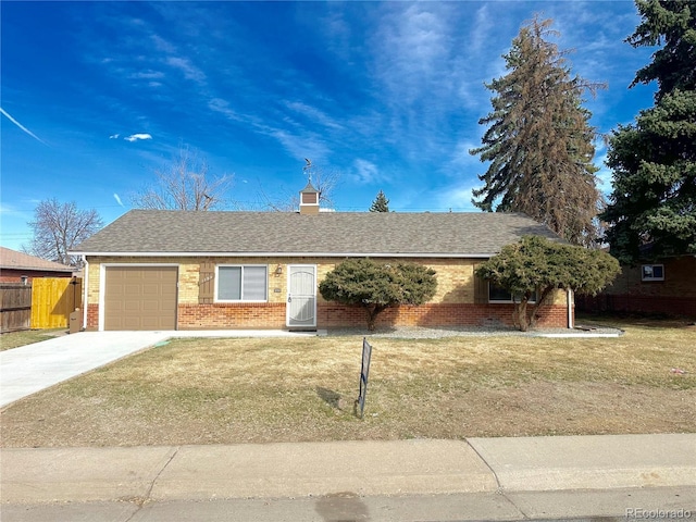 ranch-style house with a shingled roof, concrete driveway, a front lawn, a garage, and brick siding