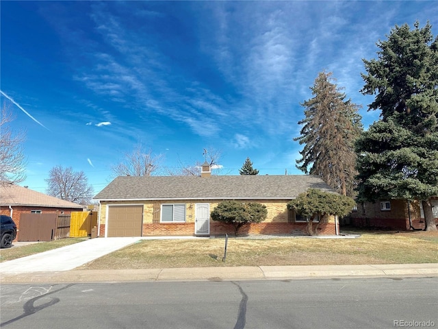 single story home featuring brick siding, an attached garage, driveway, and a front lawn