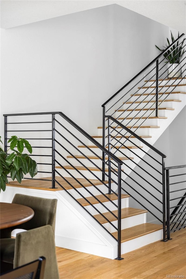 stairs featuring hardwood / wood-style flooring