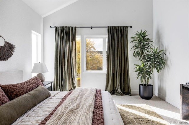 carpeted bedroom with vaulted ceiling