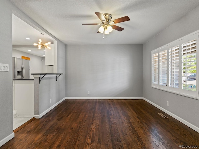1785 Geneva St, Aurora, CO 80010 - empty room with ceiling fan, wood finished floors, a chandelier, a textured ceiling, and recessed lighting